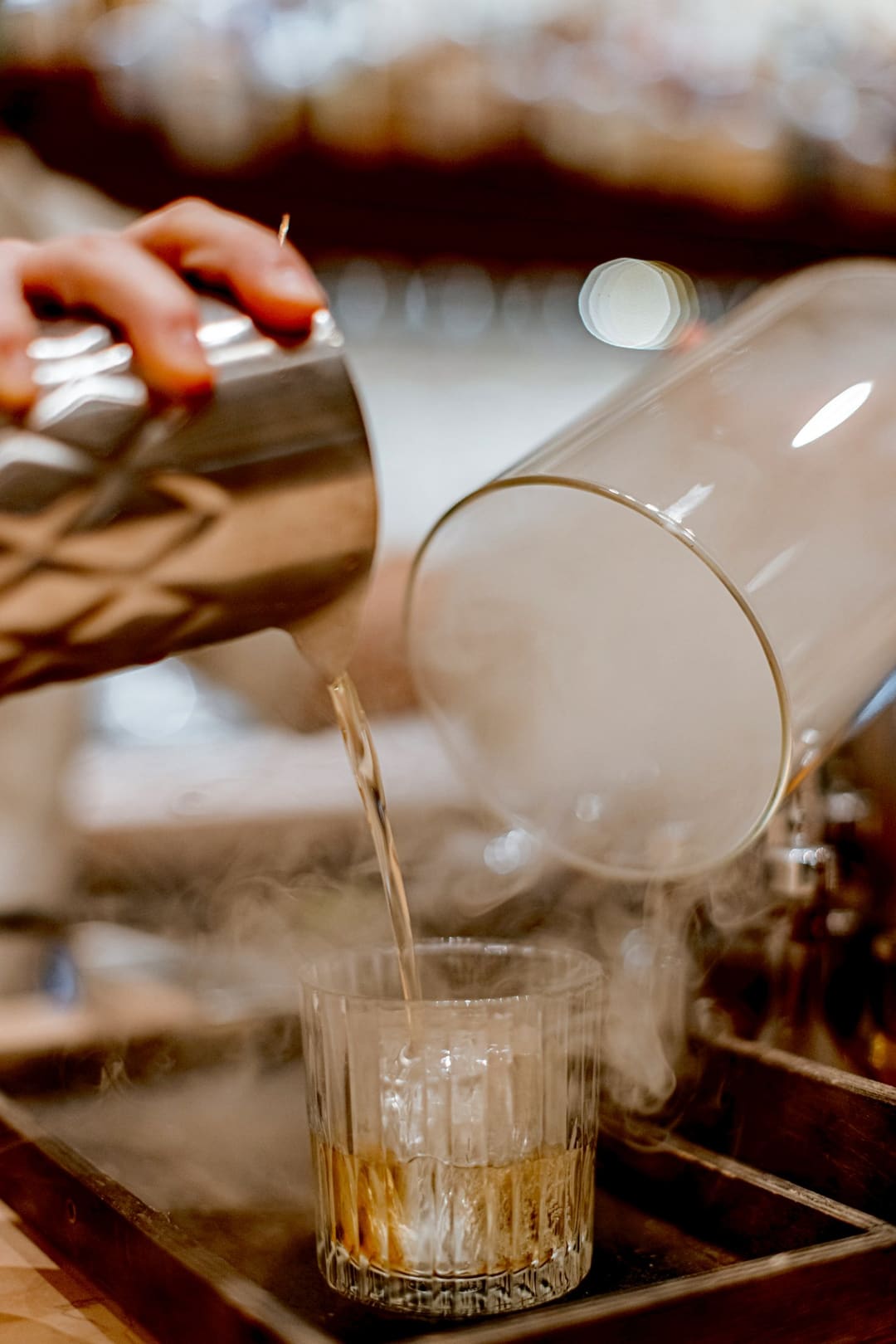 A cocktail poured into a smoke-filled glass